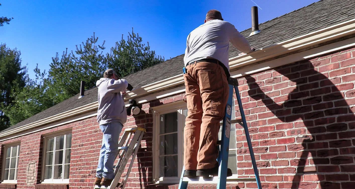 A&A Seamless Gutters crew installing seamless gutters on a home