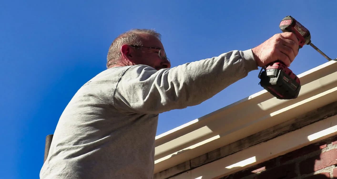 A&A technician repairing gutters